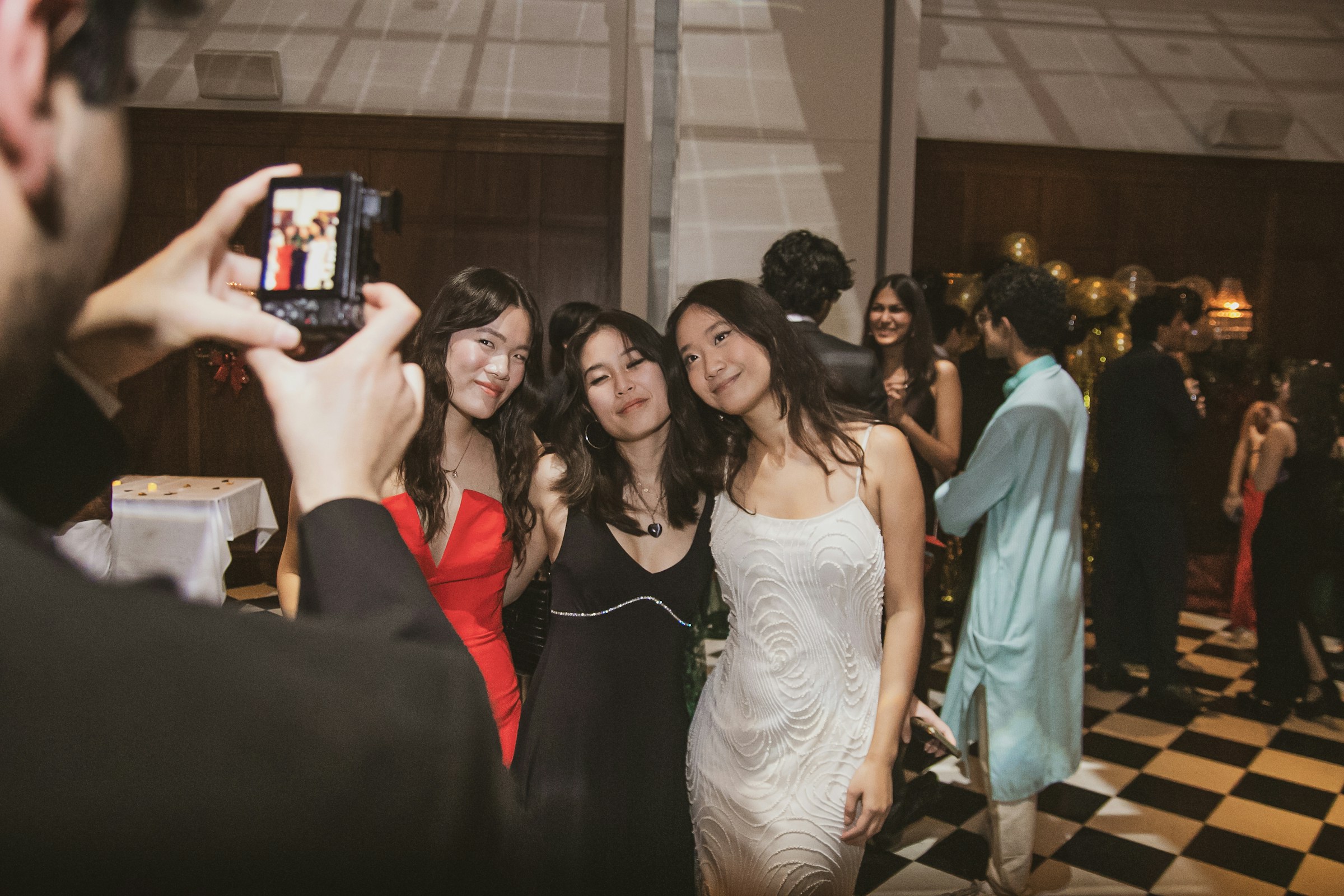 Stylishly dressed friends posing together for an event portrait